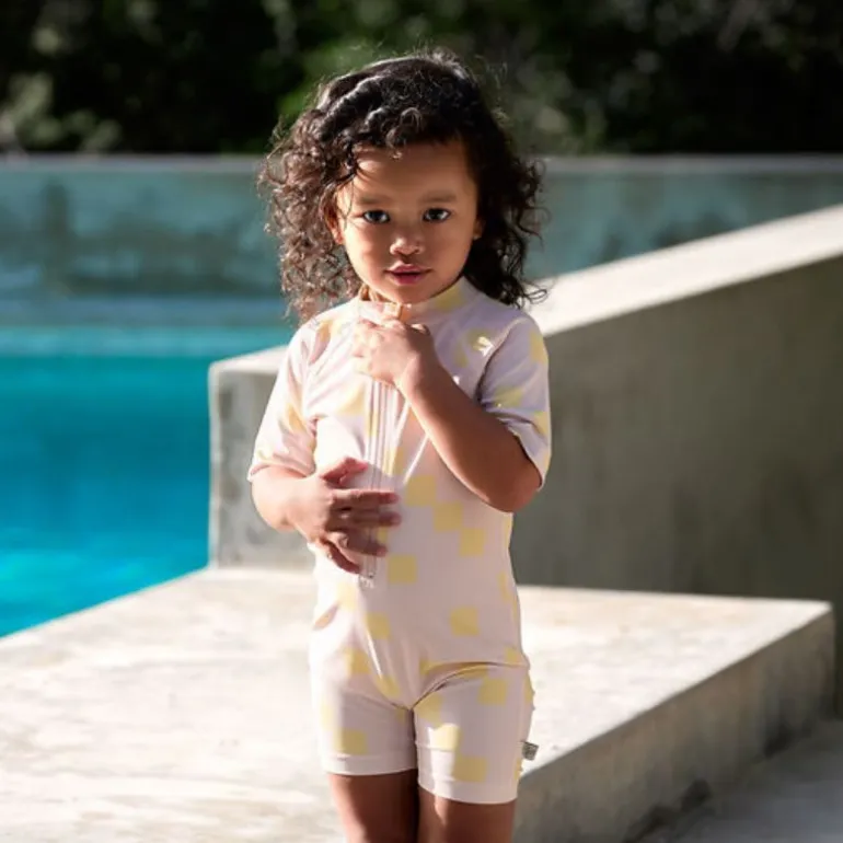 Combinaison bébé anti-UV - Lassig - Motif damier rose pâle/jaune